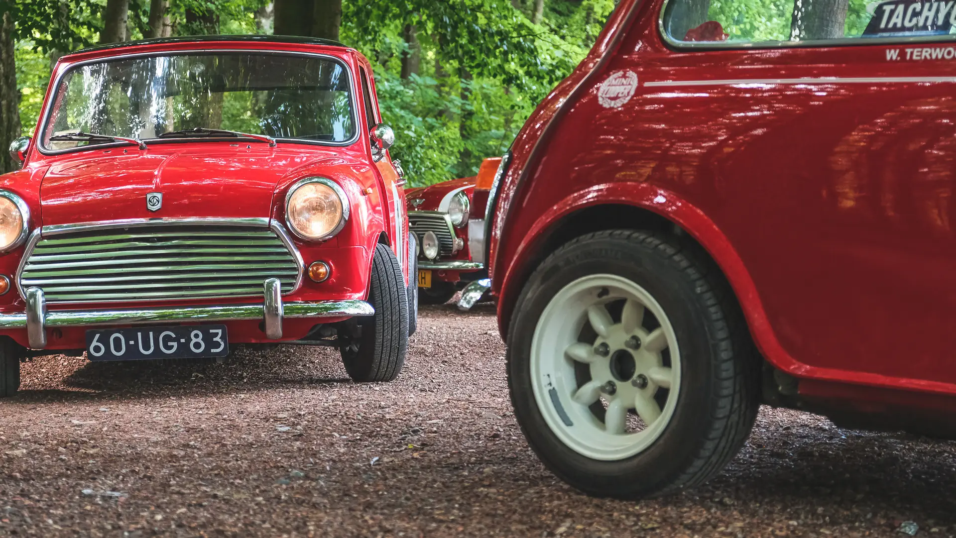 The Mini 1100 Special standing between different other red Mini's