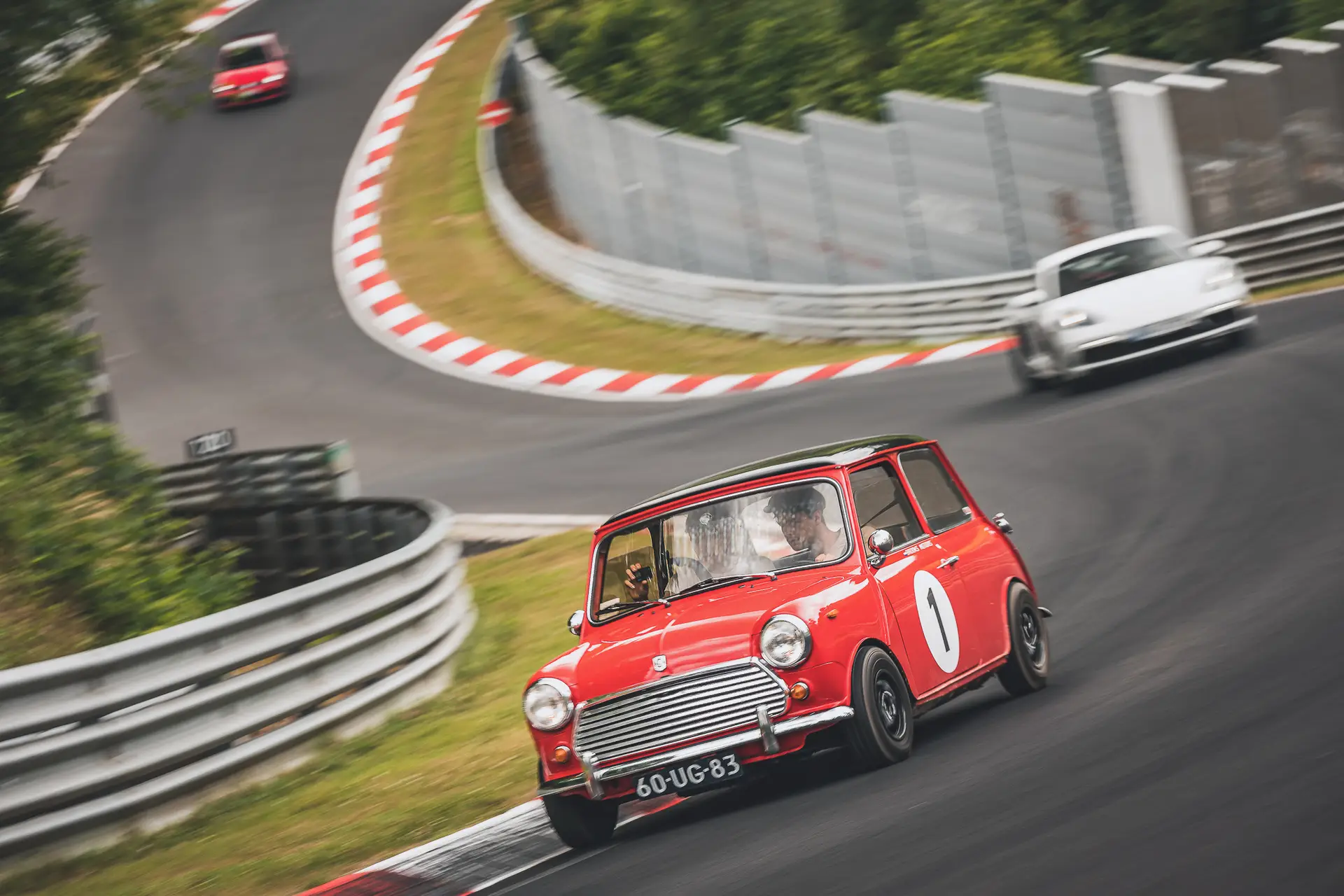 The red Mini 1100 Special racing on a race track