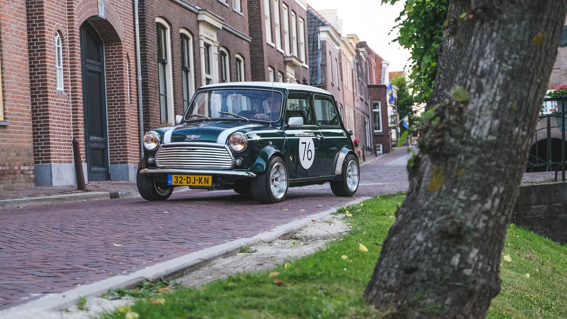 The Brooks motors Mini Cooper S driving through small streets and next to canals in the Netherlands