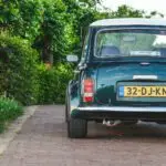 A Mini Cooper S standing on a porch