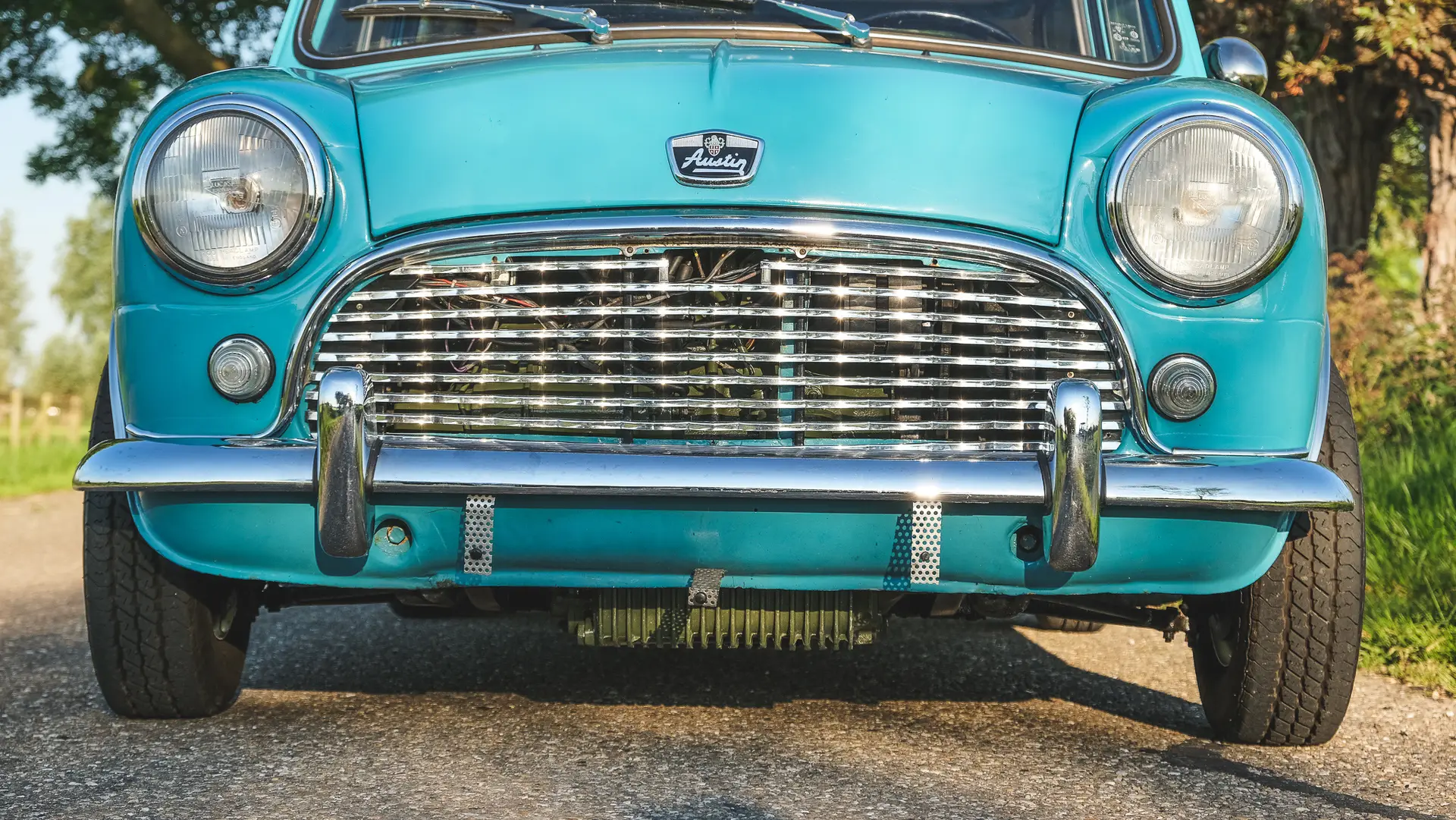 The front of an Austin Mini Cooper S with the logo and roaster clearly shown