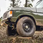 land rover range rover with yokohama tyres standing on a tree in offroad course brooks motors