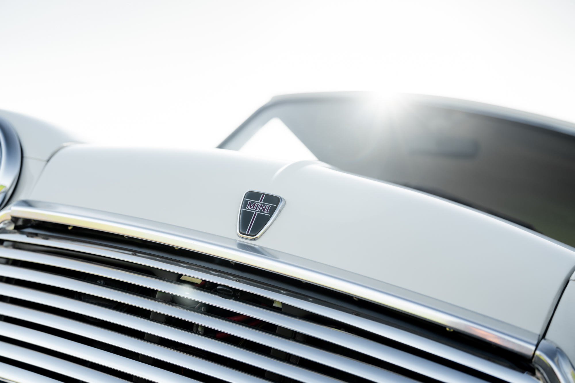 close-up of the front grille on a 1992 white Mini Classic Automatic from Brooks Motors with beautiful MINI badge on the bonnet